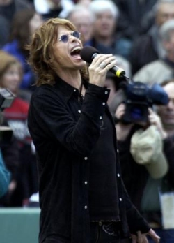 Singer and Boston native Steven Tyler, from the rock group Aerosmith sings the national nnthem prior to the start of the Boston Red Sox game against the Toronto Blue Jays at Fenway Park on opening day, Monday, April 1, 2002. (AP Photo/Elise Amendola)