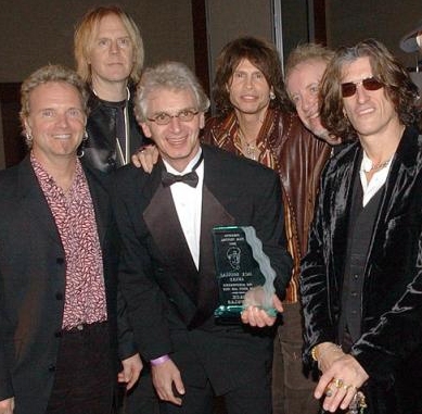 Jack Douglas, center, along with the members of the rock group, Aerosmith, from left, Joey Kramer, Tom Hamilton, Steven Tyler, Brad Whitford and Joe Perry celebrate at the Fifth Annual Sarasota Film Festival in Sarasota, Florida, Sunday, Feb. 2, 2003. . Music and film producer Jack Douglas was honored with a Lifetime Achievement Award. Douglas produced several Aerosmith albums as well as John Lennon's final album, 'Double Fantasy'. (AP Photo/DMI, Dan Herrick)
